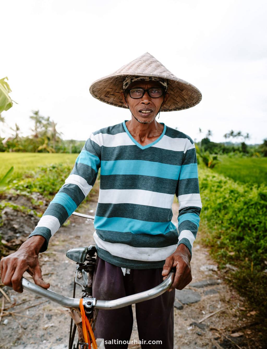 local balinese man working on rice terraces