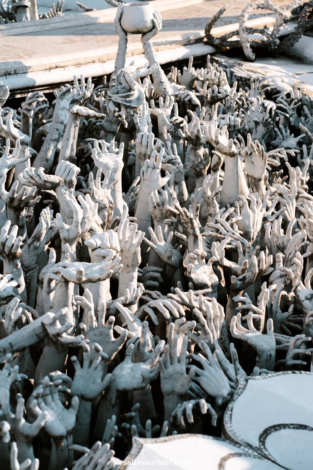 Hand sculpture white temple Chiang Rai
