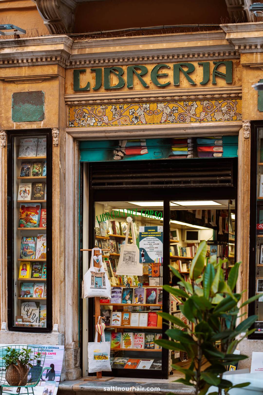 A bookstore with a sign reading Libreria above the entrance, books and tote bags displayed outside, and plants in the foreground&mdash;one of the charming things to do in Trapani sicily