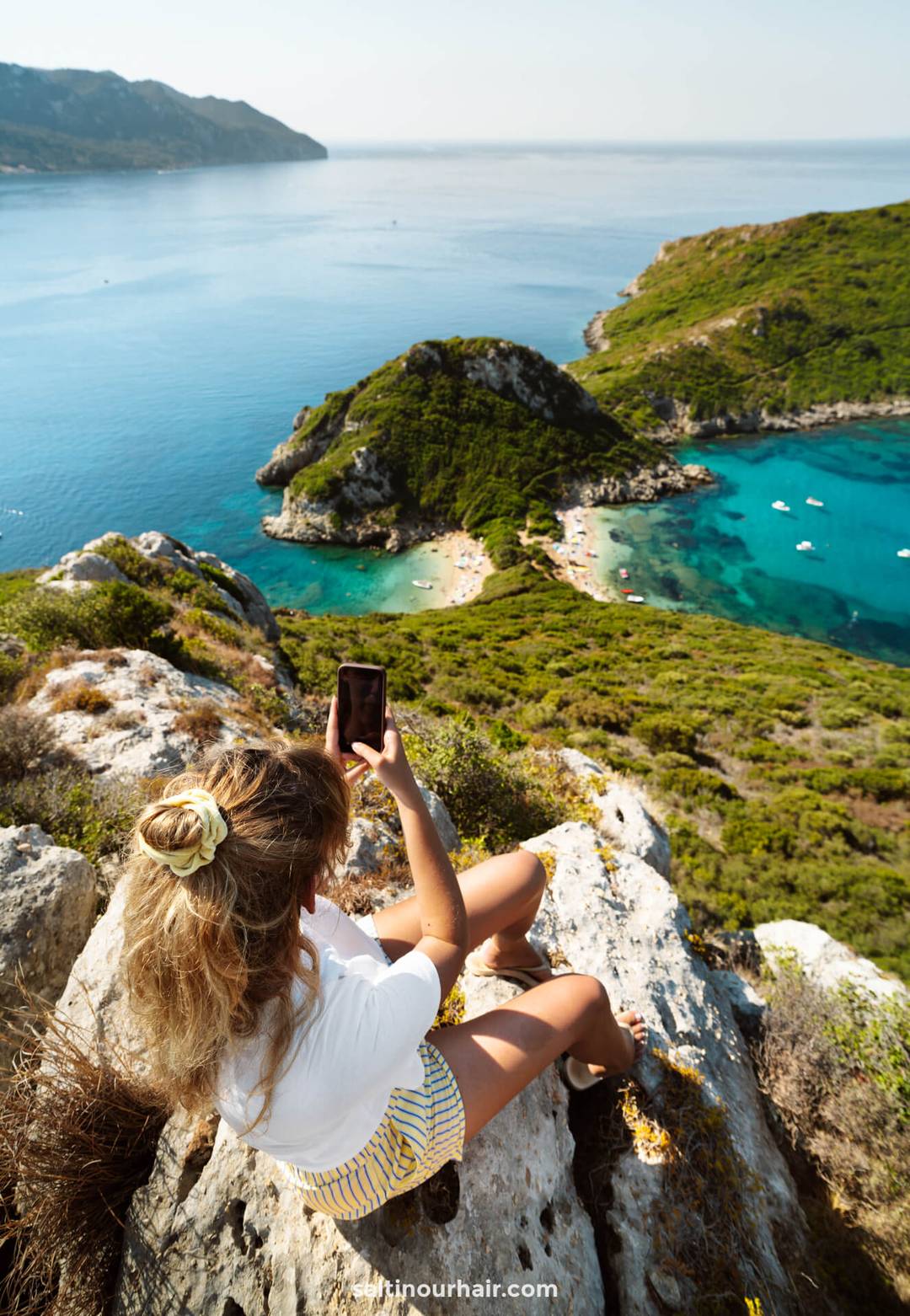 best esim girl taking photos with iphone in corfu greece