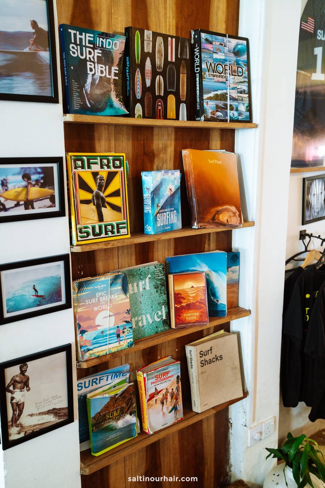 Wooden bookshelf displaying surf books including Afro Surf and Surf Shacks in a surf shop in Ahangama, Sri Lanka.