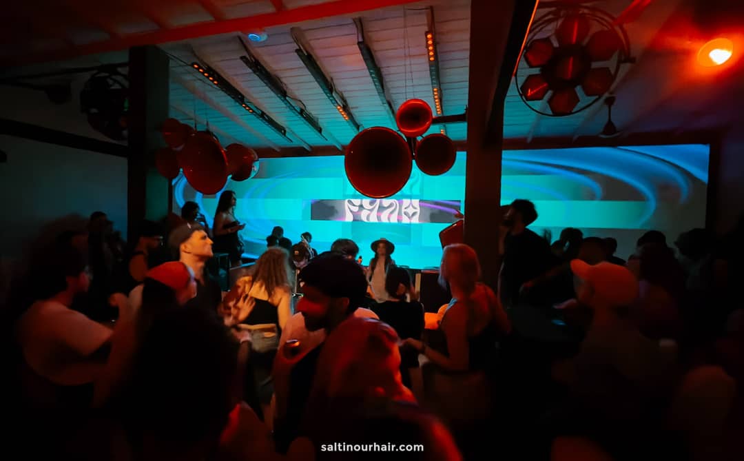 Crowd dancing at Fuse Club Ahangama with red sphere decor and teal LED video wall backdrop.